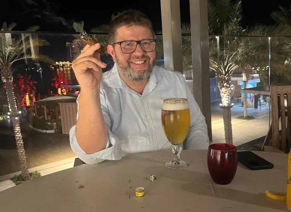 George smoking a cigar and a beer after successful delegation