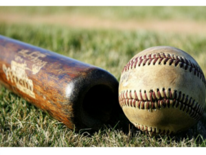 picture of a ball and an old weathered baseball bat on the grass