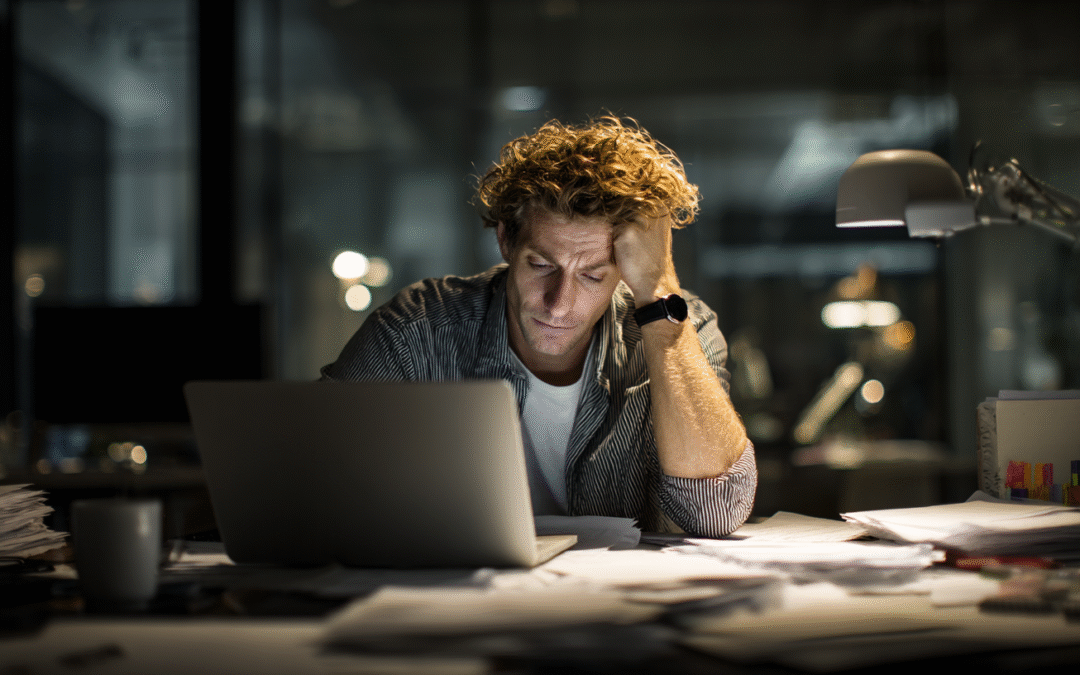 Business owner looking stressed while reviewing low profit margin reports on a desk