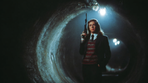 Business woman holding an M16 in a dark tunnel